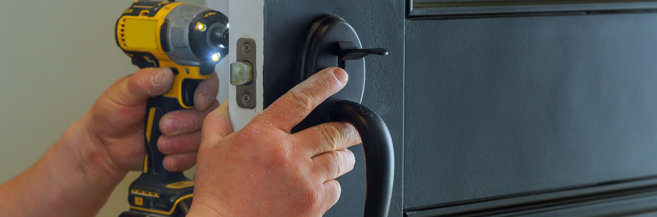 Handyman working on door